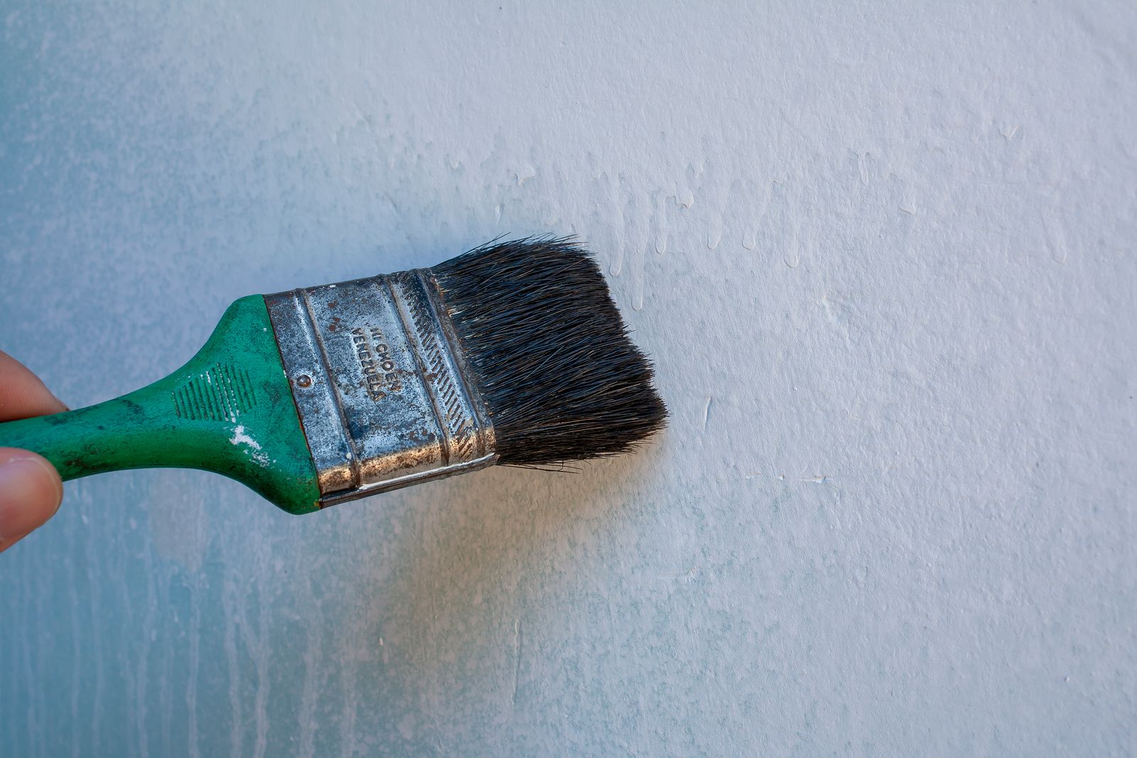 Close-up of a decorating touch-up with a brush